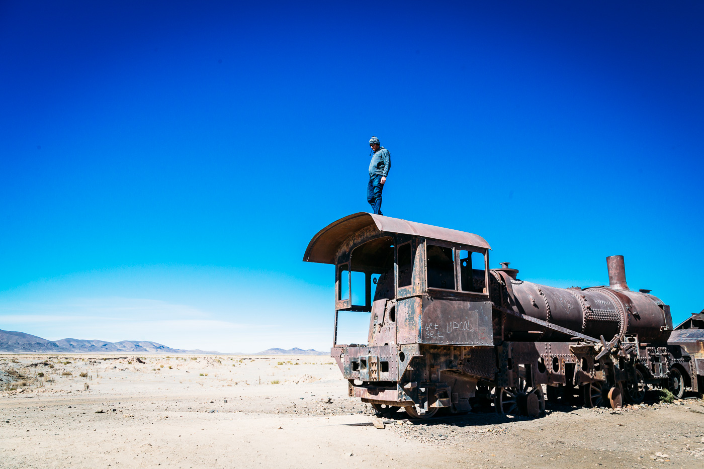 Climbing on abandoned train engines at the Train Graveyard outside of Uyuni