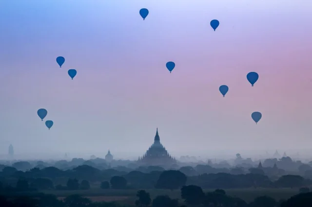 Each morning we would grab our e-bike and head over to a pagoda for sunrise.  Despite the haze it was amazing to watch the balloons fly over head. #myanmar #pagoda #hotairballoon #bagan